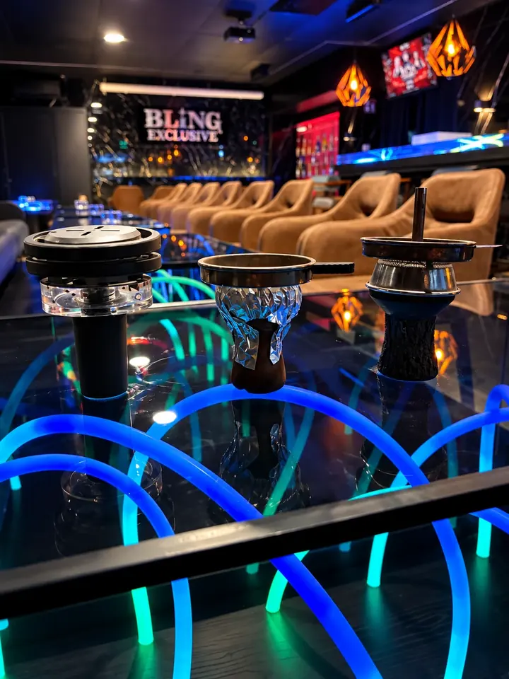 Drei Shisha-Köpfe nebeneinander auf einem Neon-Tisch, links der Quasar-Kopf